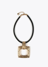 Gold-toned necklace with a black cord.